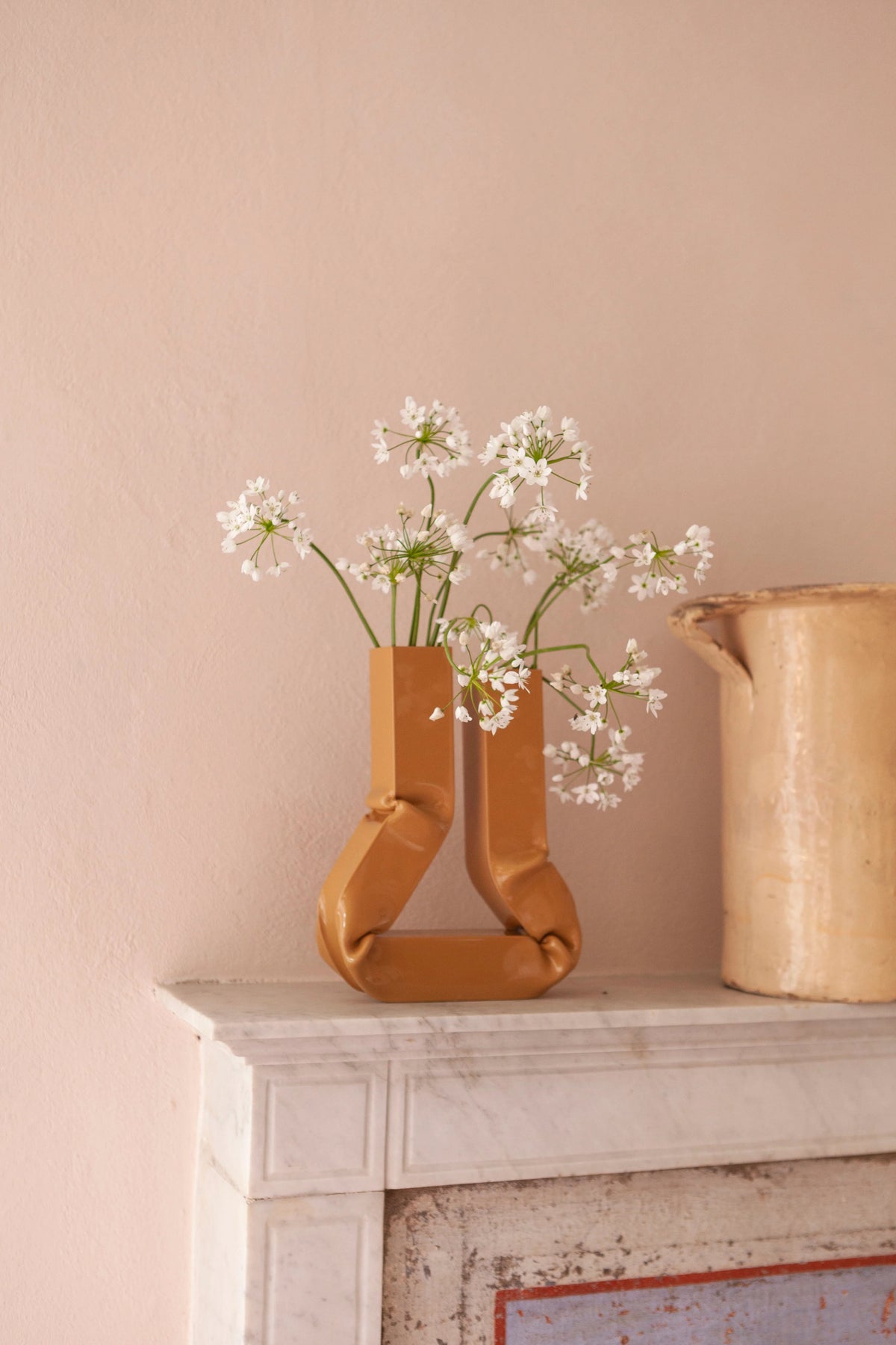 Handcrafted ceramic vase in a rich caramel color, perfect for holding fresh flowers or adding a touch of warmth to any room decor
