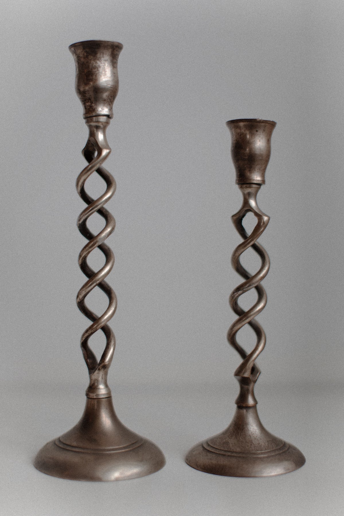Set of three brass candleholders with twisted features and antique look