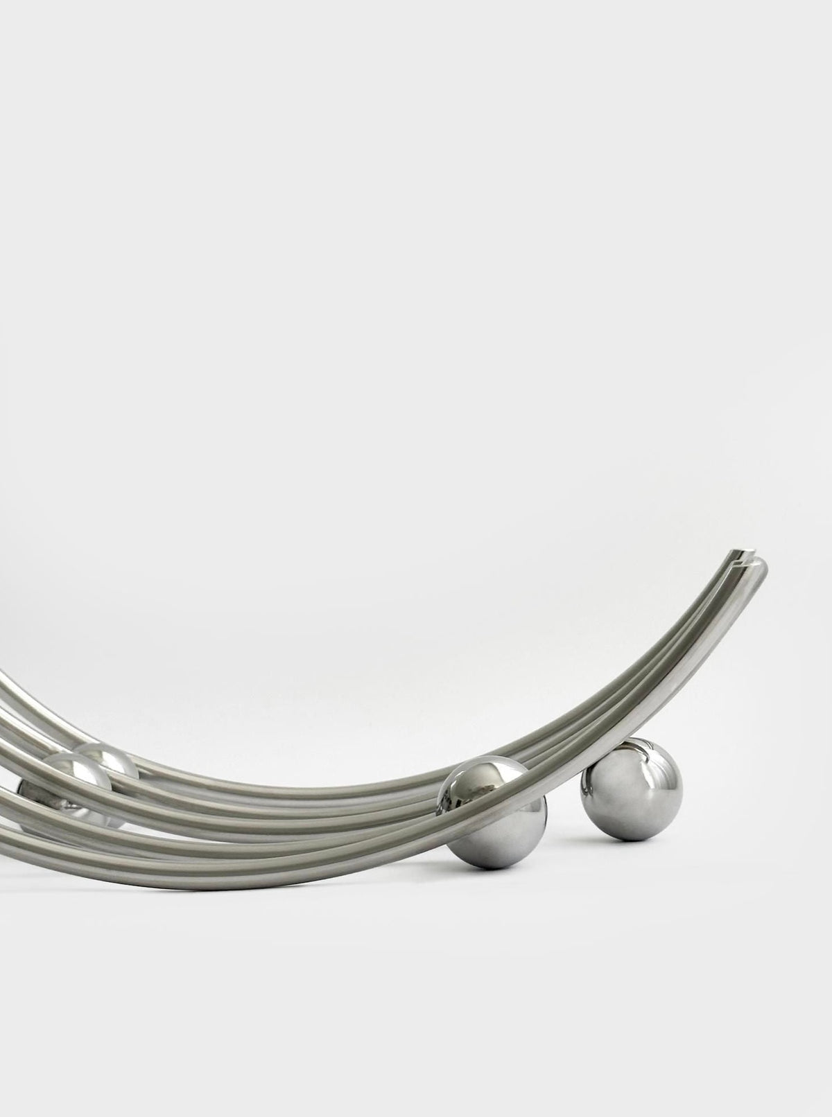 Round-shaped stainless steel serveware with smooth and curved edges for stylish presentation