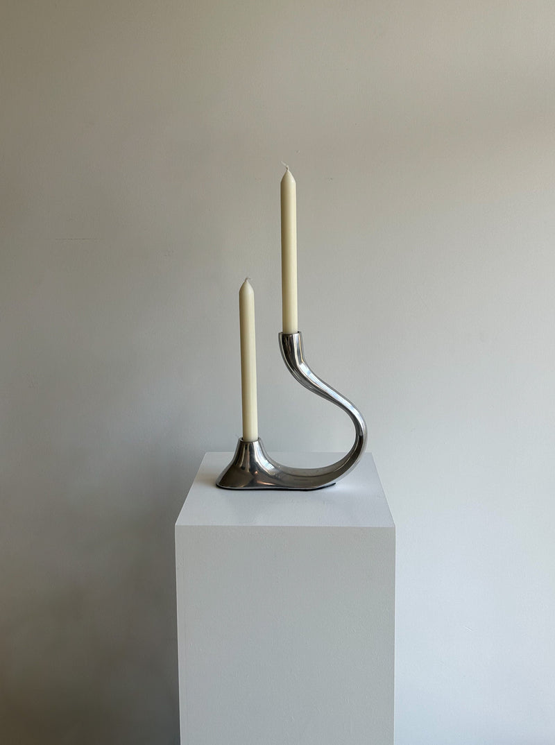 Handcrafted bronze curvy candle holder with intricate detailing and elegant design