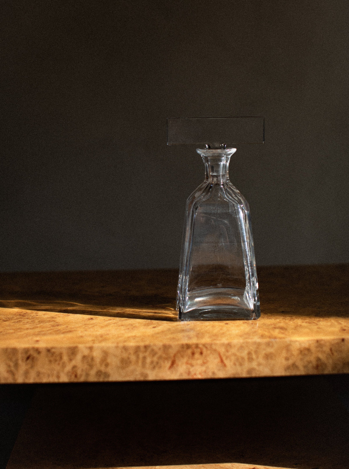 Crystal clear glass decanter with a delicate and ornate stopper