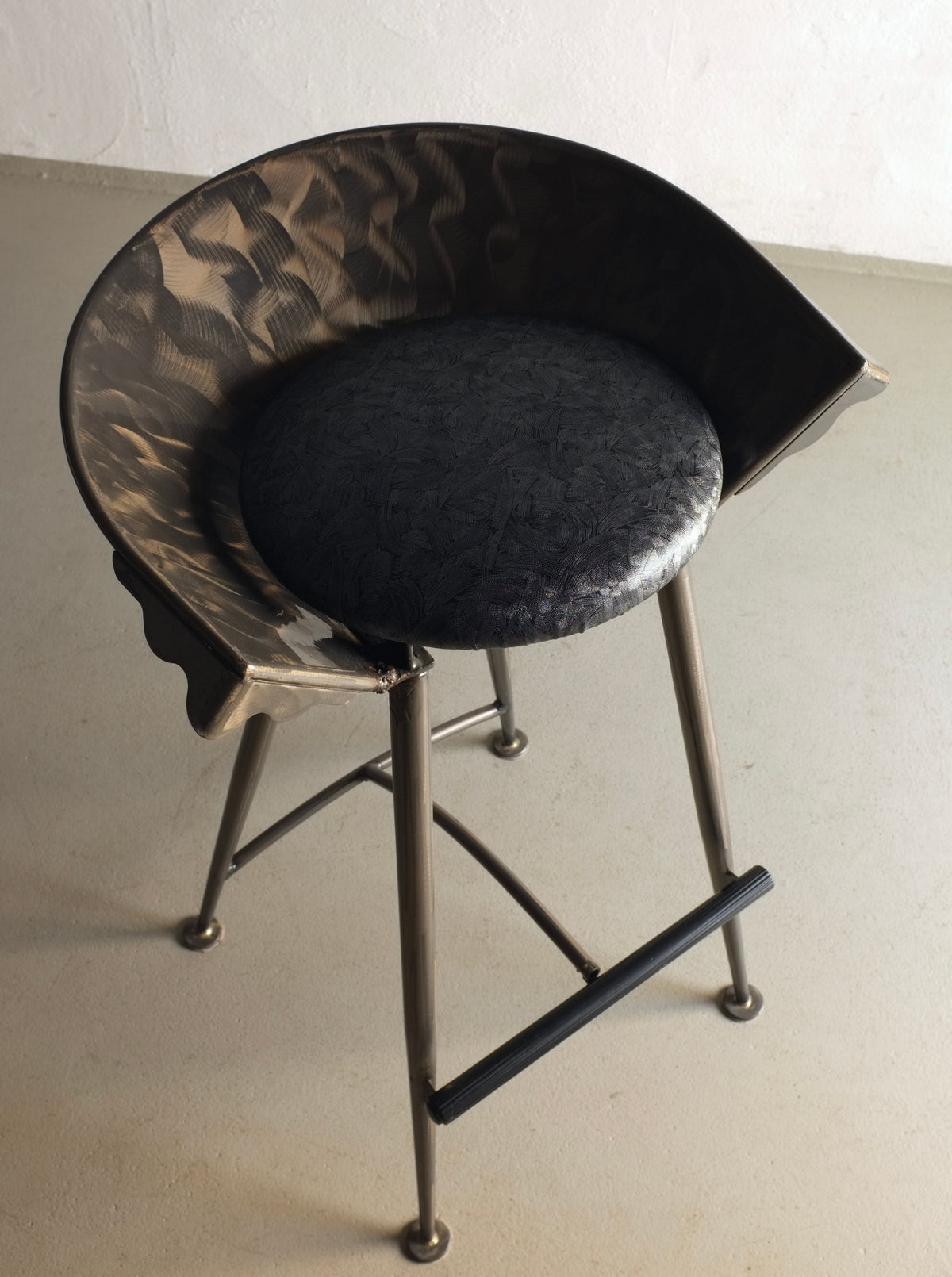 Two 1980s Brutalist style bar stools made of cast metal