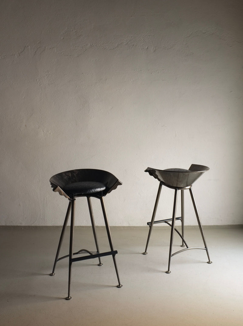 Pair of vintage 1980s Brutalist style cast metal bar stools with unique design