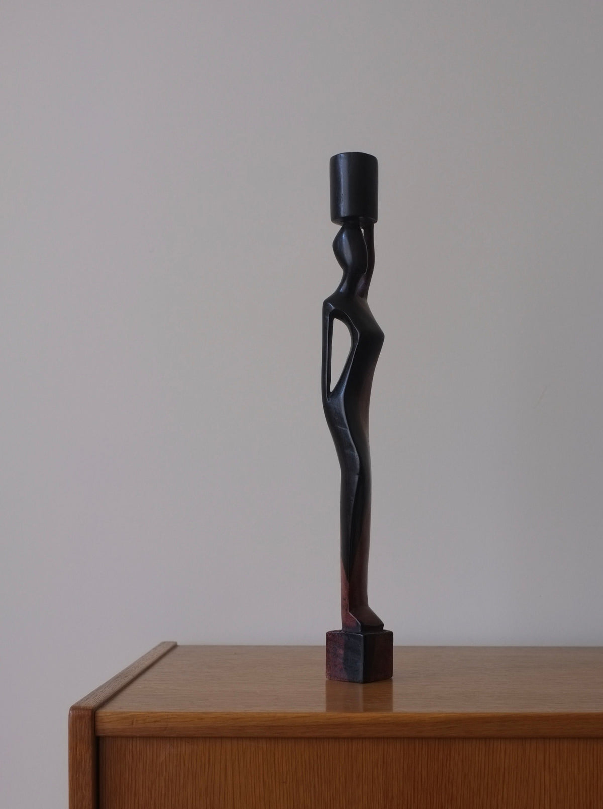 Exquisite-wooden-candleholder-featuring-a-graceful-female-form-and-detailed-embellishments