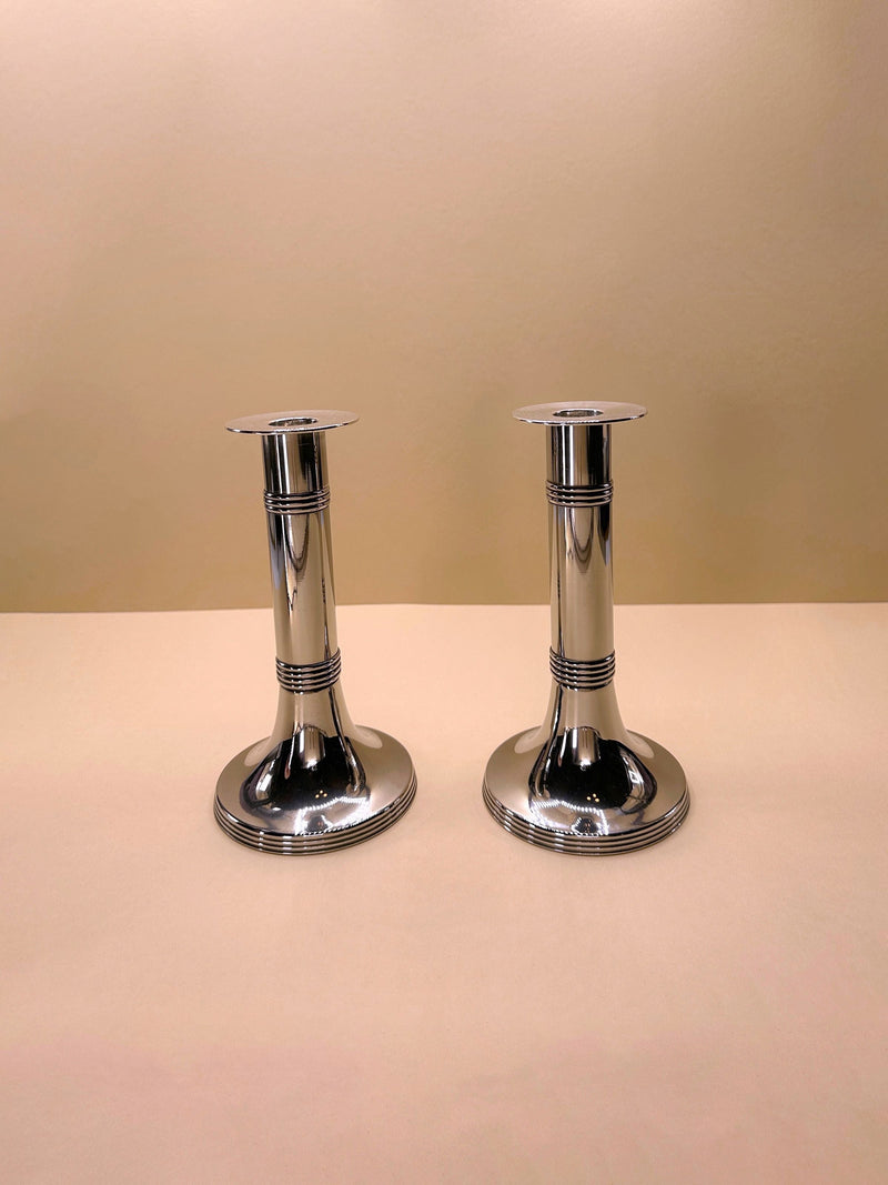 Pair of silver-plated candlesticks by Gunther Lambert, featuring intricate design and elegant curves