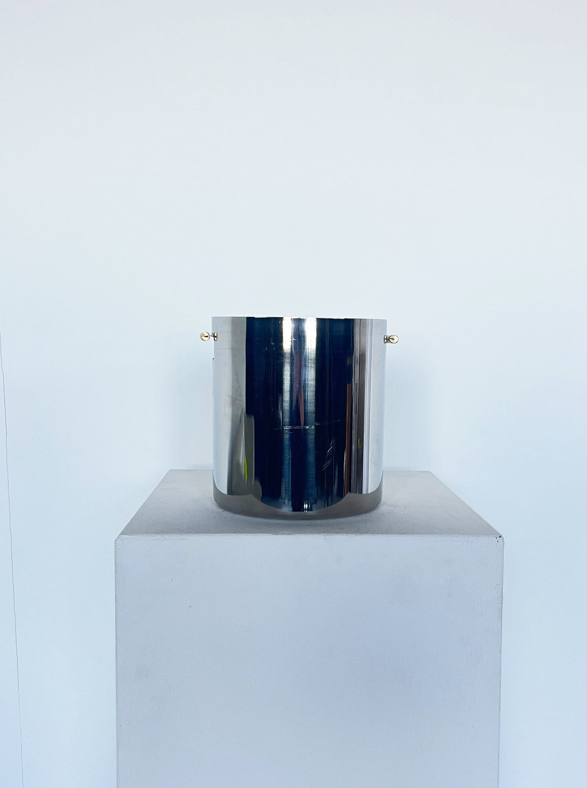 Modernist ice bucket featuring industrial-inspired brass handle
