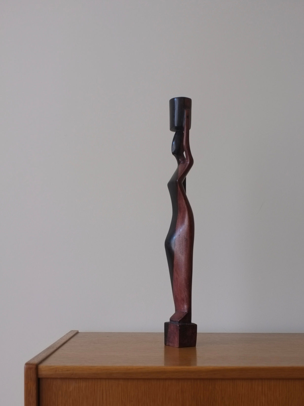 Hand-carved-wood-candleholder-depicting-a-female-figure-with-flowing-robes