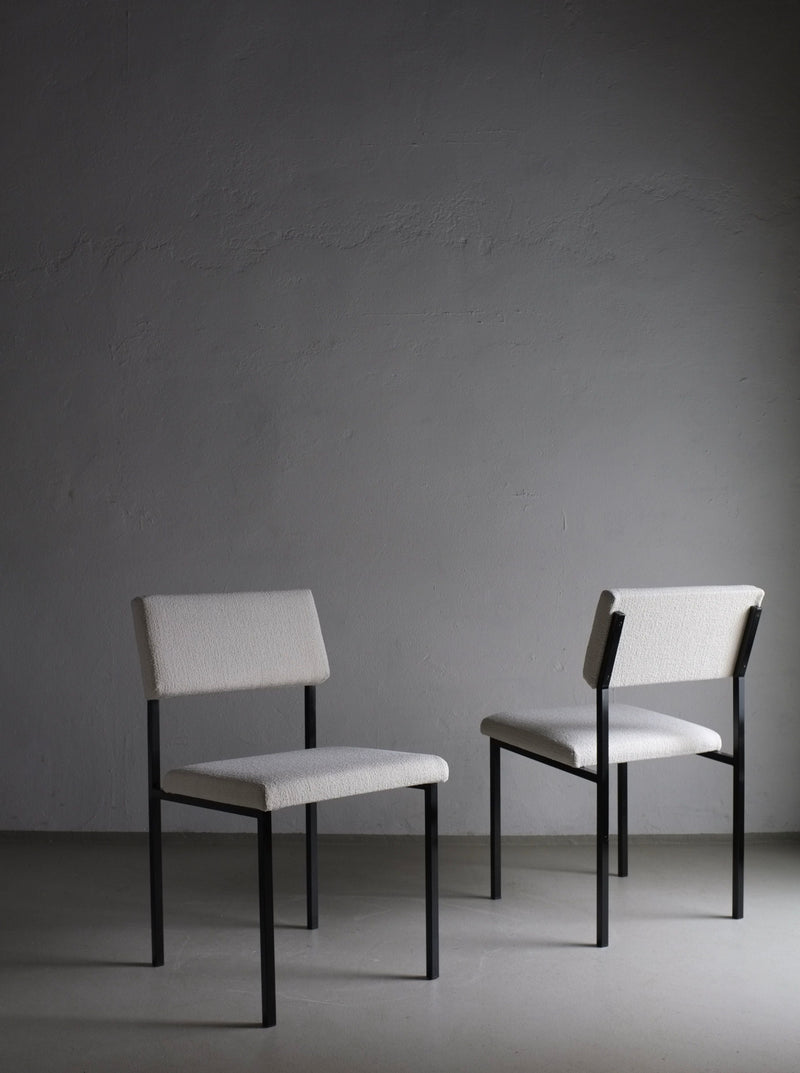 Vintage 1960s white boucle chairs with black metal frames, perfect for a modern and chic home decor aesthetic