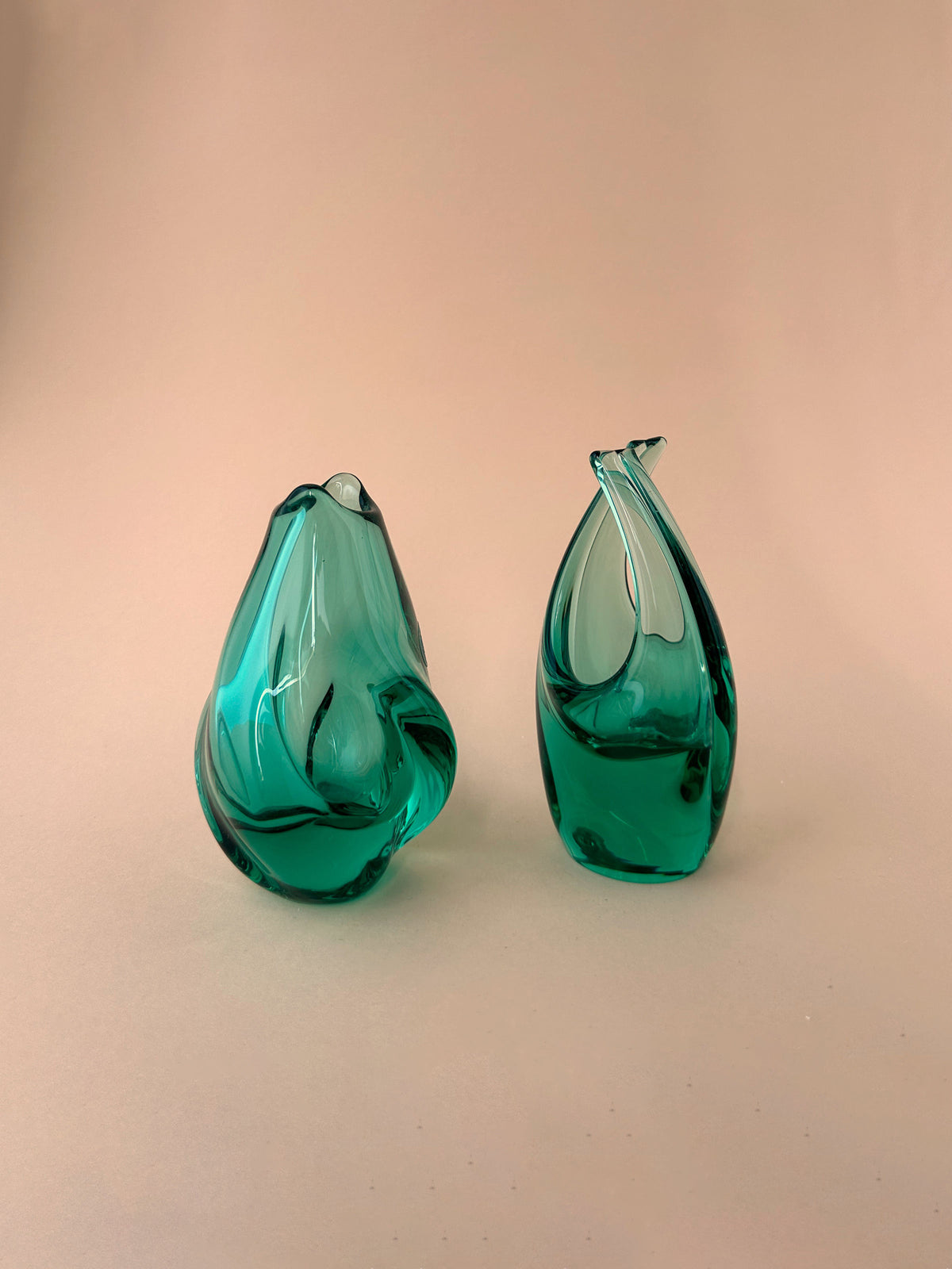 Two Vase + Basket Bowls in Turquoise By Miroslav Klinger with abstract, curvy shapes on a plain pink background by Dodo Vintage.