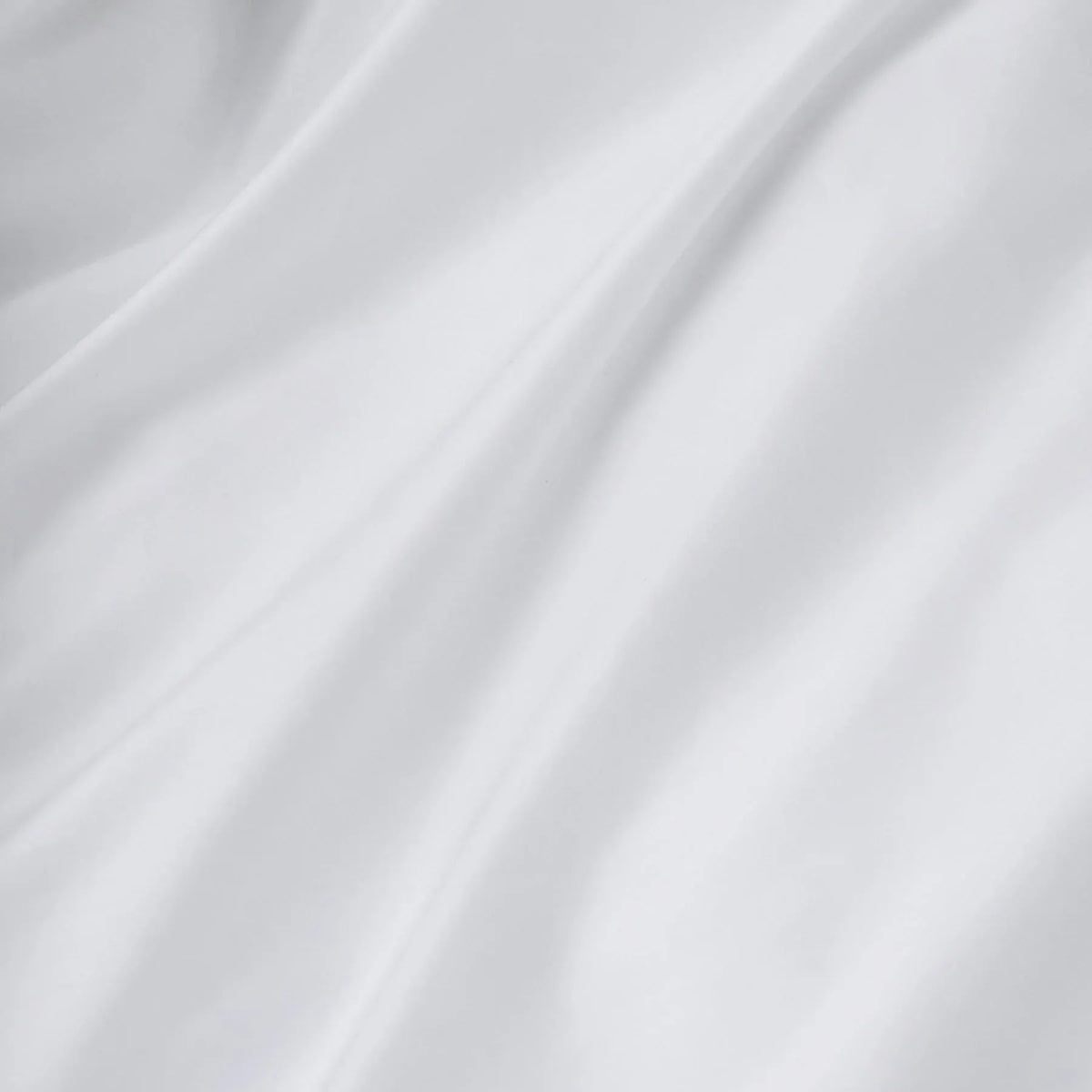 The Cotton Sateen Bed Set in White by MOST exudes a luxurious feel with its handcrafted smooth fabric, soft folds, and gentle shadows, ideal for high-end interiors.