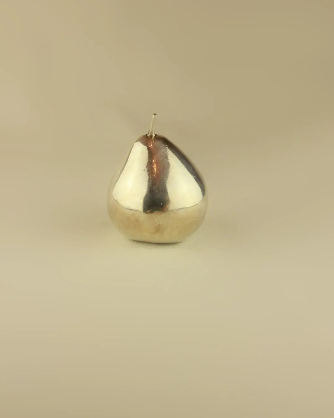 Elegant silver pear sculpture with a sleek and modern design