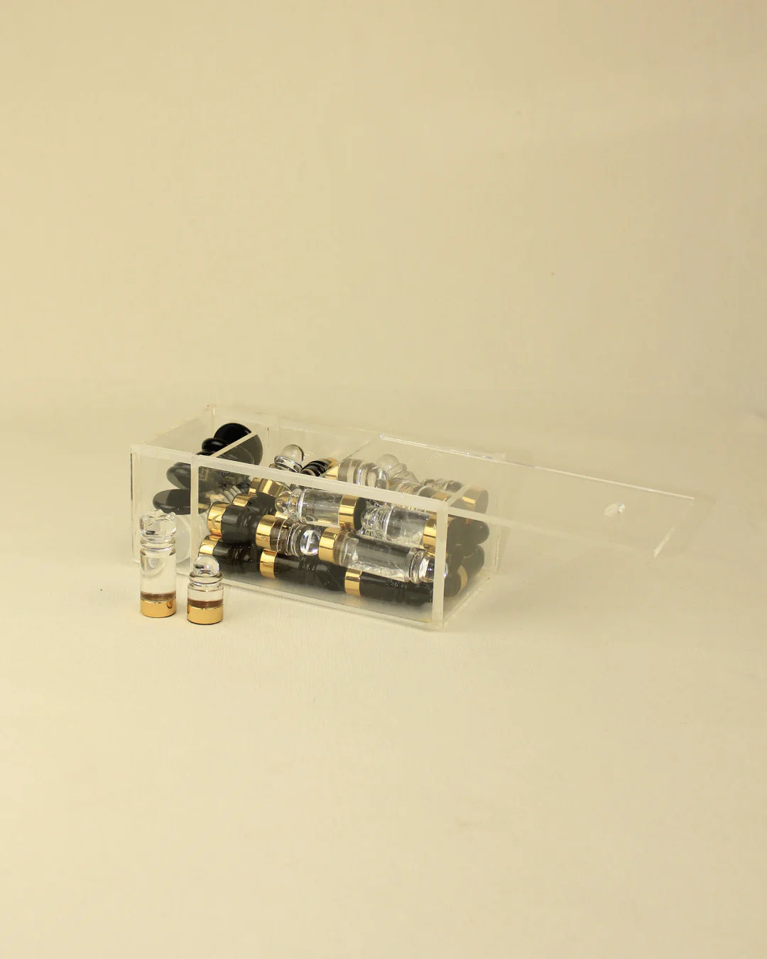 A chess & checker board from Boga Avante Shop, containing several metallic and glass vacuum tubes with brass accents, displayed on a light beige background.