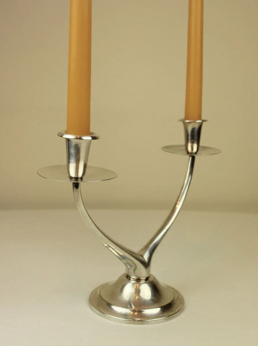 Black metal wishbone candleholder with elegant design and two candle slots