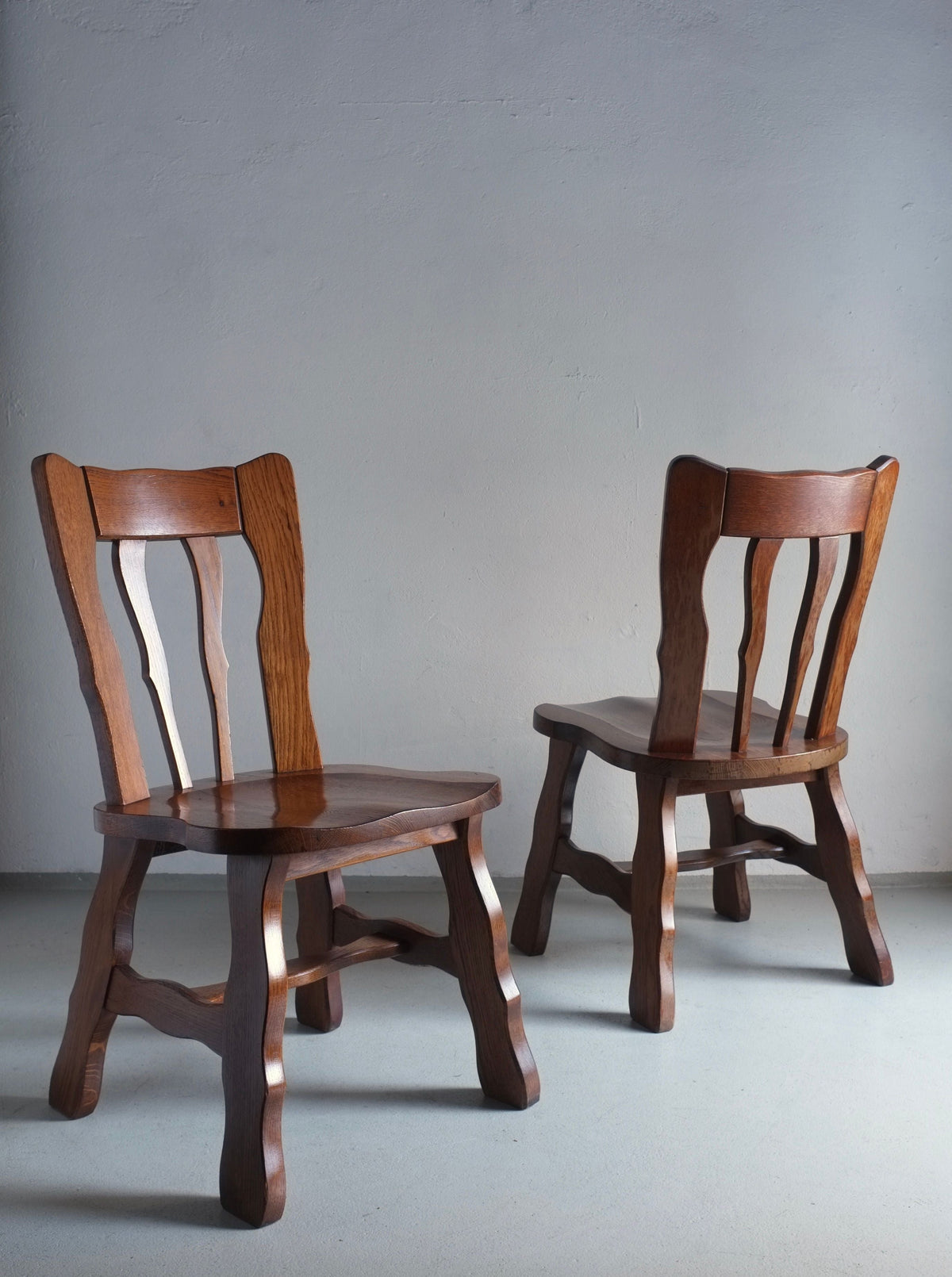 Pair of vintage 1970s Brutalist style dining chairs crafted from carved oak
