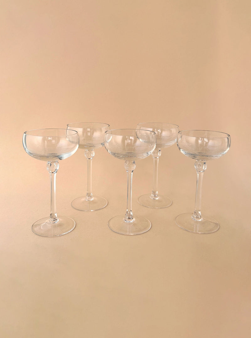 Set of 5 small champagne bowls made of clear glass with delicate rims and elegant design, perfect for serving beverages at special occasions or gatherings
