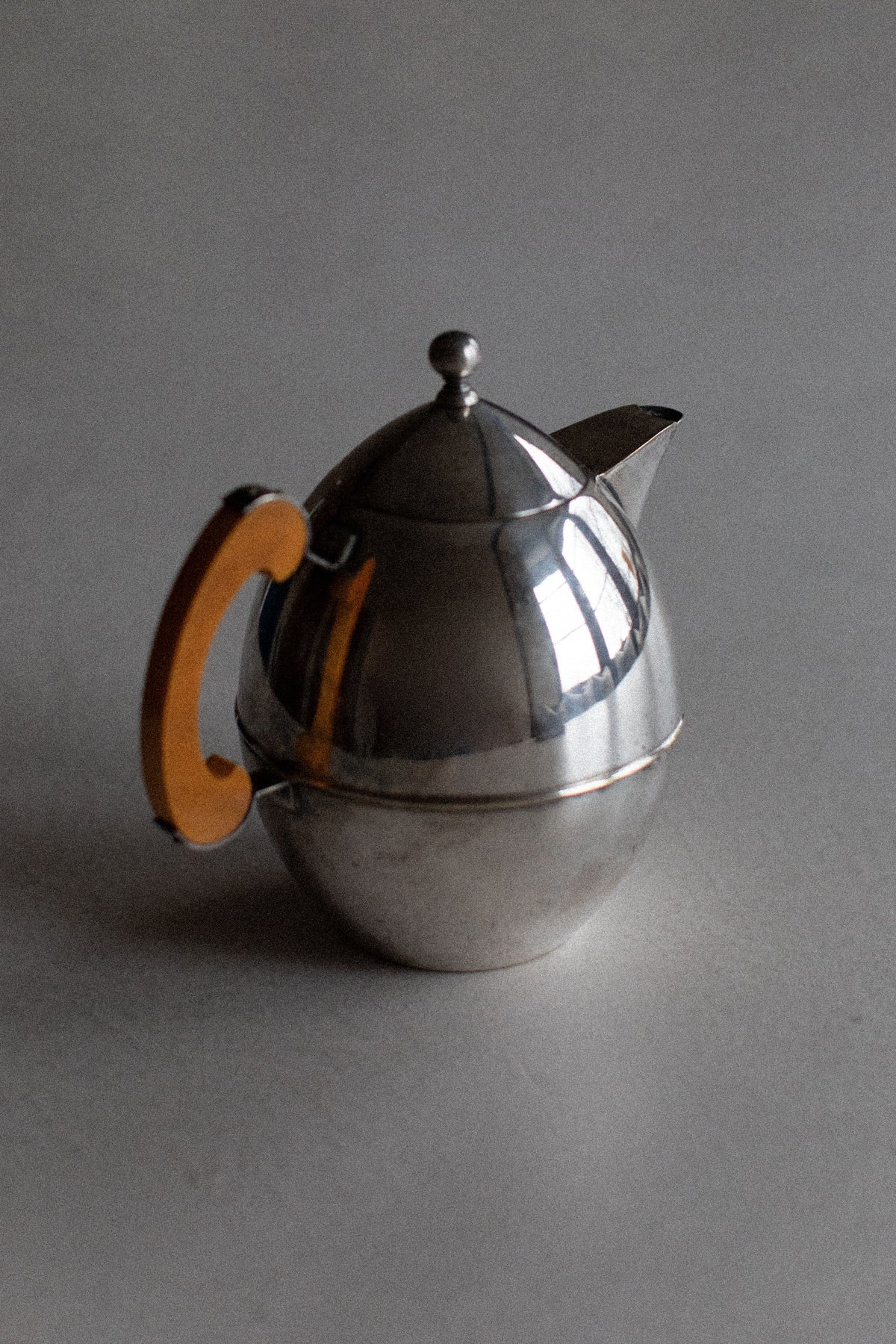 Art Deco teapot with a striking combination of bold stripes and elegant curves