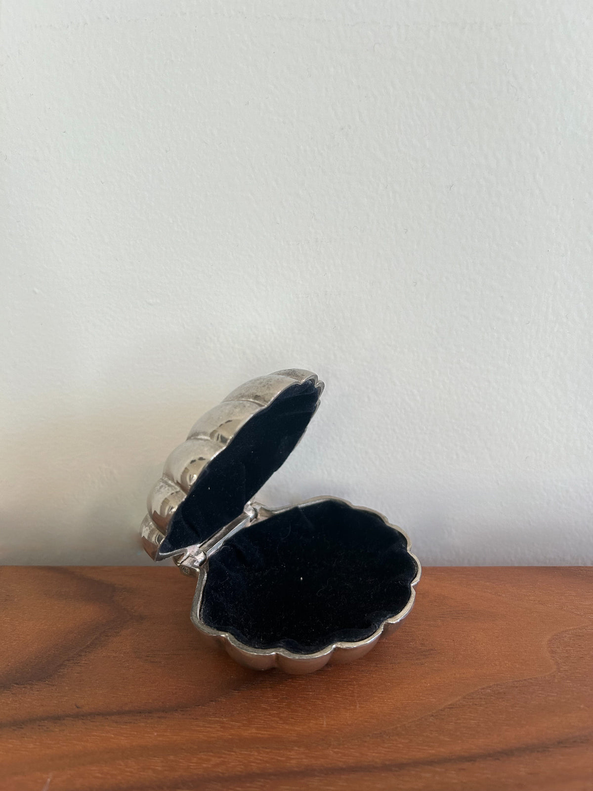 Old-fashioned trinket holder adorned with seashells and maritime motifs