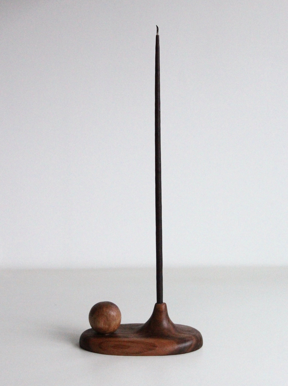 Handcrafted circle and wood incense holder with intricate carved details