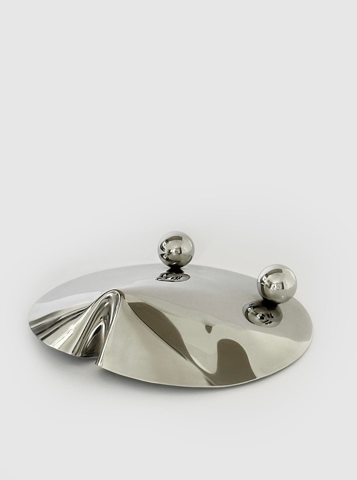 Large stainless steel serving bowl with raised base for elegant display